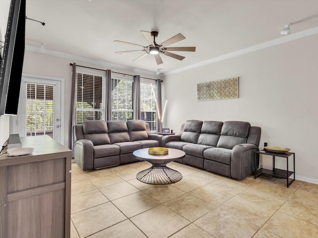 living room with ornamental molding, ceiling fan, light tile patterned flooring, and baseboards