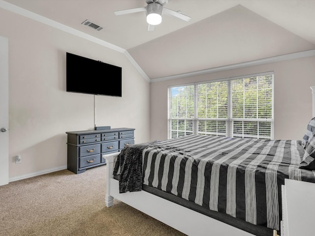 carpeted bedroom featuring visible vents, baseboards, ceiling fan, crown molding, and vaulted ceiling