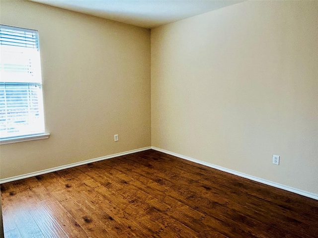 10425 Winding Passage Way, Fort Worth, TX 76131 - spare room featuring baseboards and dark wood-type flooring