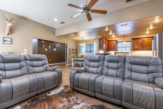 tiled living area featuring baseboards, visible vents, and a ceiling fan