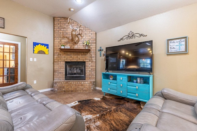 living area with lofted ceiling, a fireplace, and baseboards