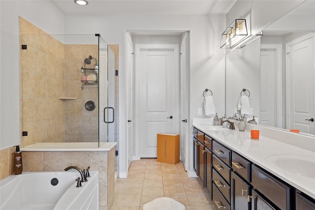 full bath featuring a sink, double vanity, a stall shower, tile patterned floors, and a garden tub