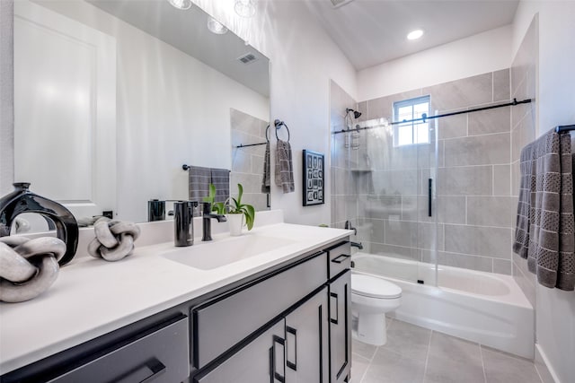 bathroom featuring visible vents, washtub / shower combination, toilet, vanity, and tile patterned flooring