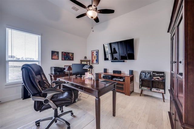 office with ceiling fan, light wood-style flooring, vaulted ceiling, visible vents, and baseboards