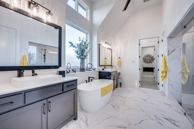 full bathroom featuring a high ceiling, marble finish floor, a sink, and a marble finish shower