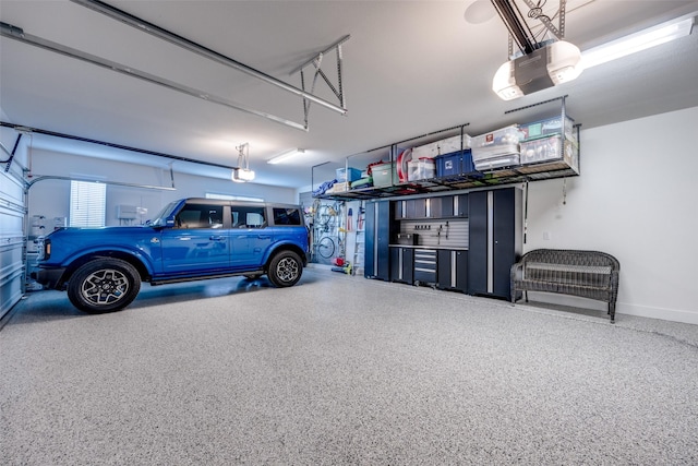 garage featuring baseboards and a garage door opener