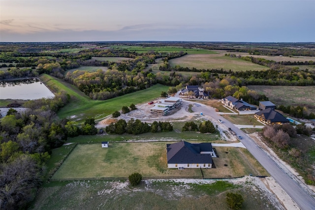 aerial view with a rural view and a water view