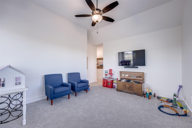 sitting room featuring carpet flooring, baseboards, and a ceiling fan