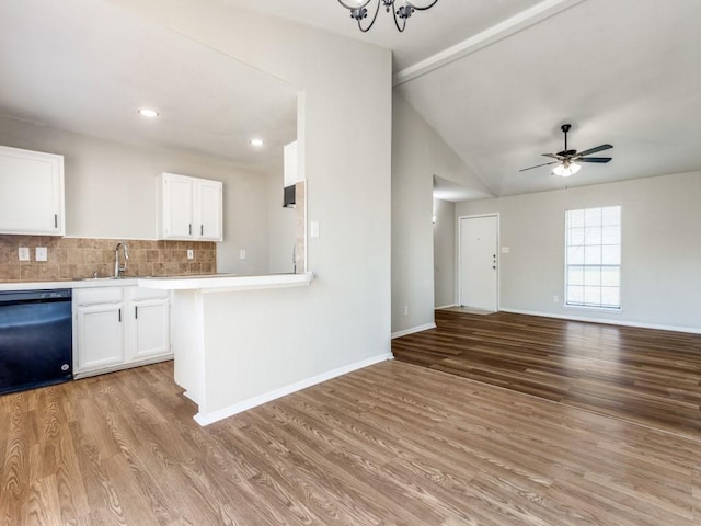 kitchen featuring black dishwasher, light countertops, white cabinetry, light wood-style floors, and open floor plan