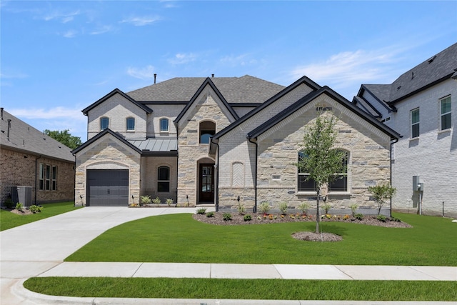 3811 Lochwood Dr, Rowlett, TX 75088 - french country inspired facade featuring stone siding, concrete driveway, a front yard, and a garage