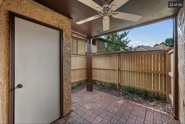 view of patio with fence and a ceiling fan