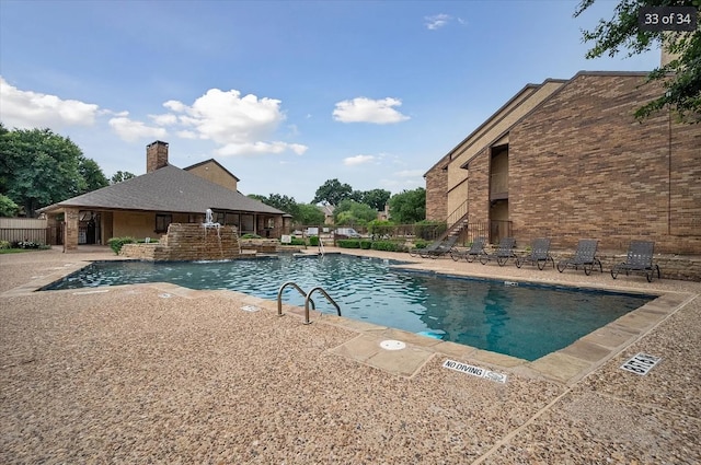 pool featuring a patio and fence