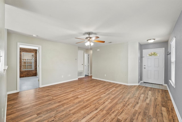 117 Independence Ave, Venus, TX 76084 - unfurnished living room with light wood-style flooring, ceiling fan, and baseboards