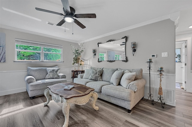 1210 Carla Dr, Denison, TX 75020 - living area featuring a ceiling fan, wood finished floors, crown molding, and wainscoting