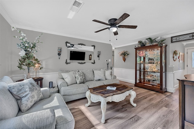 1210 Carla Dr, Denison, TX 75020 - living room with ornamental molding, wainscoting, ceiling fan, and wood finished floors