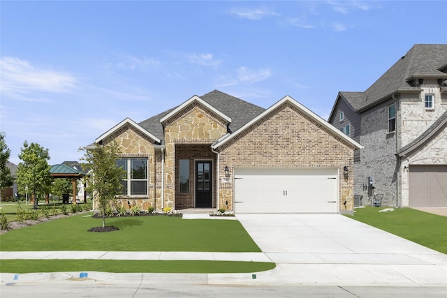 view of front facade with a front yard, an attached garage, stone siding, brick siding, and driveway