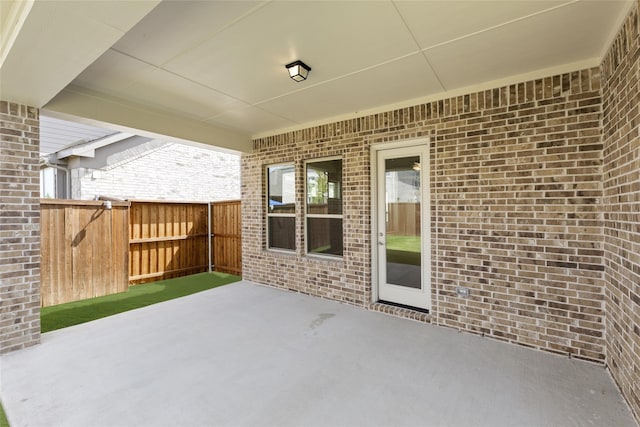 view of patio featuring fence