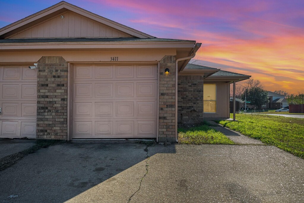 3411 Stonewall Ln, Fort Worth, TX 76123 - view of front of house featuring brick siding, stone siding, and a garage