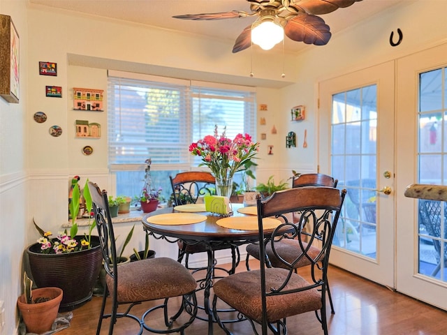 1317 Swiss Ct, Plano, TX 75023 - dining area featuring a ceiling fan, wainscoting, wood finished floors, and ornamental molding