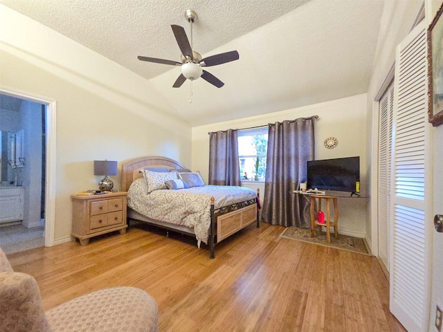 1317 Swiss Ct, Plano, TX 75023 - bedroom with vaulted ceiling, light wood-style flooring, a textured ceiling, ensuite bathroom, and ceiling fan