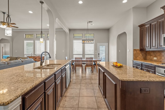 1109 Mount Ln, Rhome, TX 76078 - kitchen with a sink, a kitchen island, open floor plan, decorative backsplash, and recessed lighting