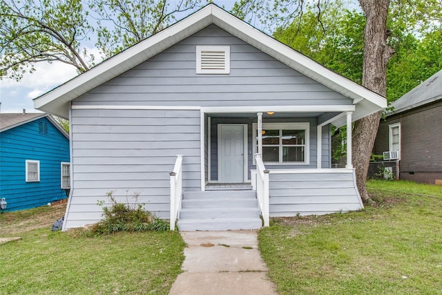 309 W Monterey St, Denison, TX 75020 - bungalow-style home with a porch, cooling unit, and a front lawn