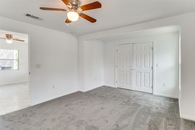 309 W Monterey St, Denison, TX 75020 - unfurnished bedroom featuring ceiling fan, carpet, a closet, visible vents, and baseboards