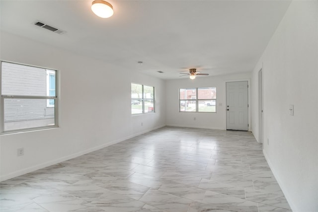 309 W Monterey St, Denison, TX 75020 - spare room featuring marble finish floor, baseboards, a ceiling fan, and visible vents