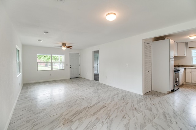 309 W Monterey St, Denison, TX 75020 - interior space featuring marble finish floor, ceiling fan, and baseboards