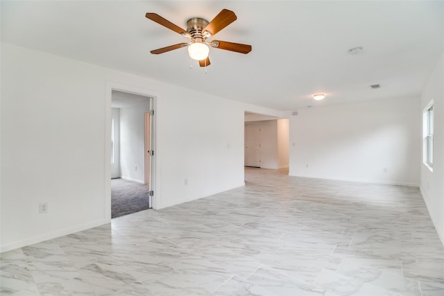 309 W Monterey St, Denison, TX 75020 - spare room with baseboards, marble finish floor, and a ceiling fan