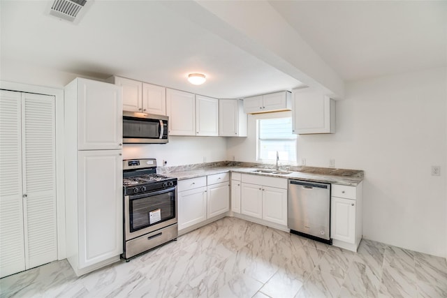 309 W Monterey St, Denison, TX 75020 - kitchen featuring white cabinetry, visible vents, appliances with stainless steel finishes, marble finish floor, and a sink