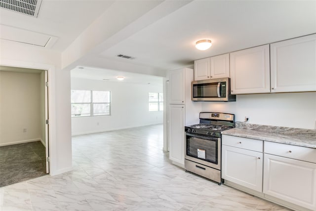 309 W Monterey St, Denison, TX 75020 - kitchen with visible vents, white cabinetry, marble finish floor, and stainless steel appliances