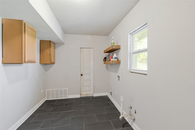 laundry area with cabinet space, hookup for a gas dryer, baseboards, hookup for an electric dryer, and visible vents