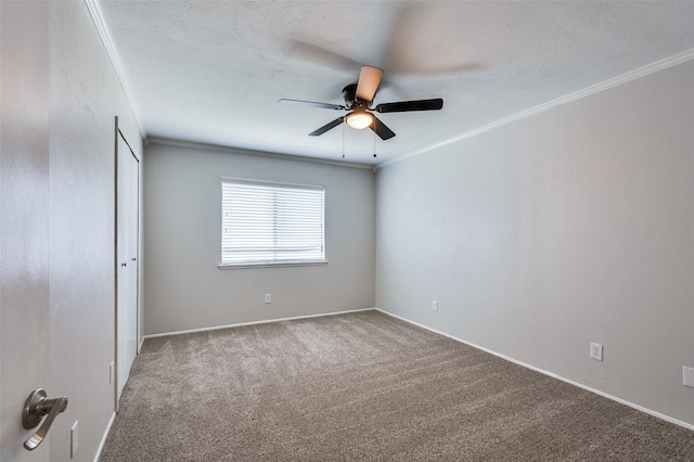 unfurnished room featuring ceiling fan, baseboards, ornamental molding, and carpet floors