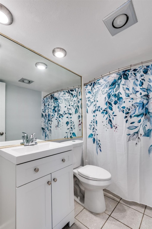 bathroom with tile patterned floors, vanity, toilet, and a shower with curtain