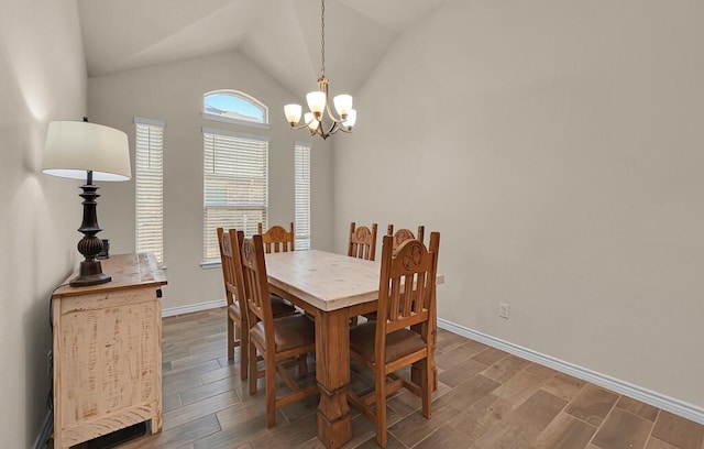 dining area with baseboards, a notable chandelier, wood finished floors, and lofted ceiling