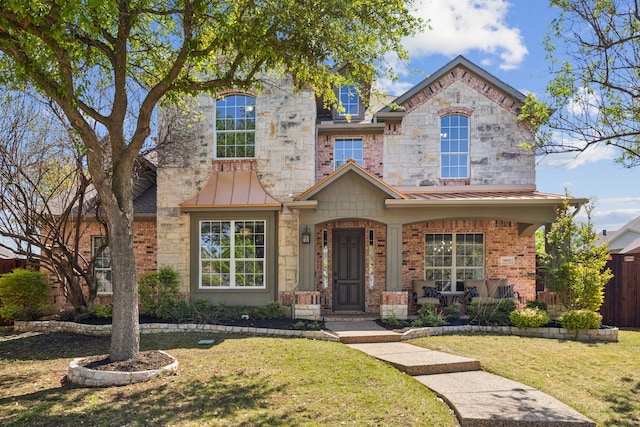 9892 Ranchero Dr, Frisco, TX 75033 - view of front of property featuring a standing seam roof, metal roof, stone siding, and a front lawn
