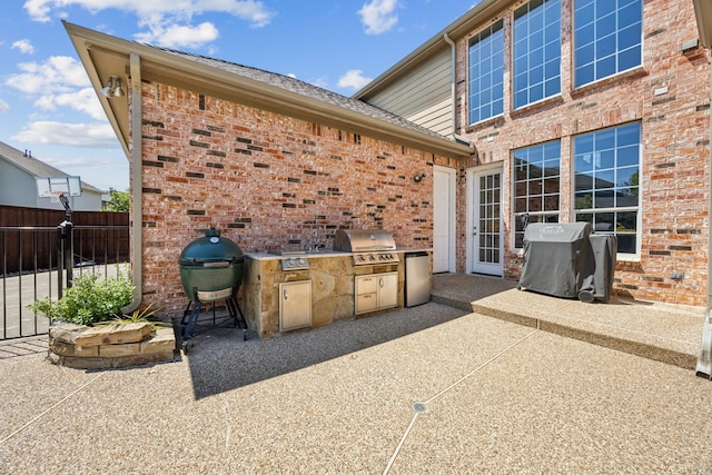 9892 Ranchero Dr, Frisco, TX 75033 - view of patio / terrace with exterior kitchen, a grill, and fence