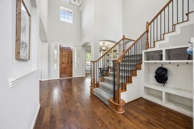 9892 Ranchero Dr, Frisco, TX 75033 - entrance foyer with hardwood / wood-style floors, stairs, plenty of natural light, and arched walkways