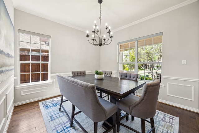 9892 Ranchero Dr, Frisco, TX 75033 - dining room with ornamental molding, wainscoting, an inviting chandelier, and dark wood-style floors