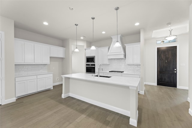 3723 Lochwood Dr, Rowlett, TX 75088 - kitchen featuring oven, a sink, premium range hood, stainless steel microwave, and tasteful backsplash