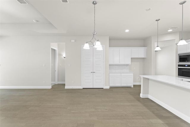 3723 Lochwood Dr, Rowlett, TX 75088 - kitchen featuring stainless steel appliances, white cabinets, light countertops, baseboards, and recessed lighting