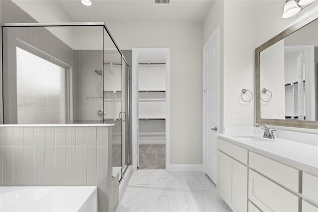 3723 Lochwood Dr, Rowlett, TX 75088 - full bathroom with marble look tiles, a stall shower, vanity, and a walk in closet
