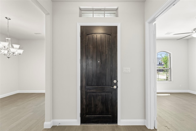 3723 Lochwood Dr, Rowlett, TX 75088 - foyer with wood finished floors, a chandelier, and baseboards