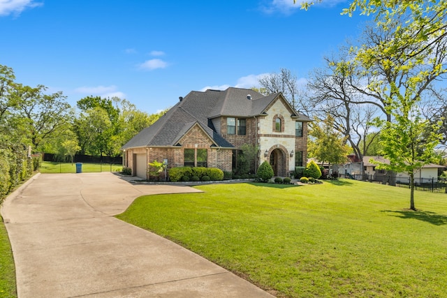 106 E Fork Rd, Sunnyvale, TX 75182 - french country inspired facade with driveway, brick siding, an attached garage, and roof with shingles