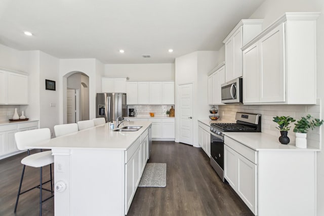 13412 Cortes De Pallas Dr, Little Elm, TX 75068 - kitchen featuring appliances with stainless steel finishes, tasteful backsplash, a sink, a kitchen breakfast bar, and recessed lighting