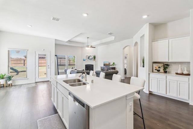 13412 Cortes De Pallas Dr, Little Elm, TX 75068 - kitchen featuring a sink, stainless steel dishwasher, arched walkways, a fireplace, and a ceiling fan