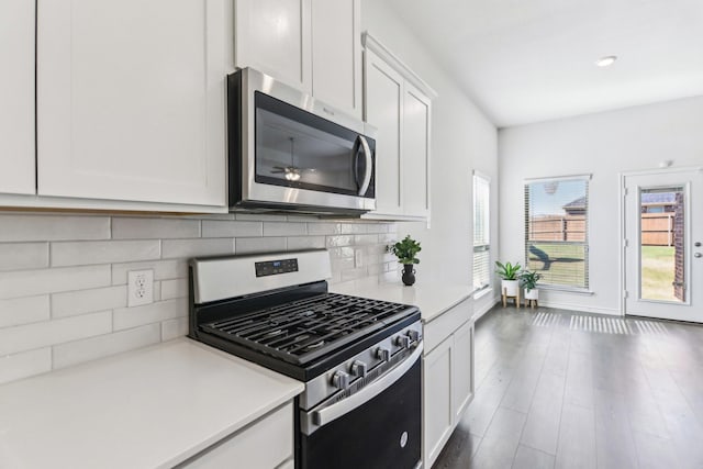 13412 Cortes De Pallas Dr, Little Elm, TX 75068 - kitchen featuring appliances with stainless steel finishes, light countertops, white cabinetry, backsplash, and wood finished floors
