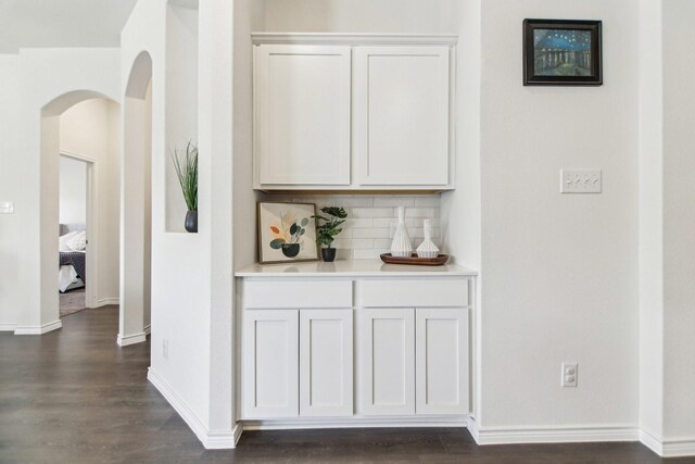 13412 Cortes De Pallas Dr, Little Elm, TX 75068 - hallway featuring arched walkways, dark wood-style floors, and baseboards