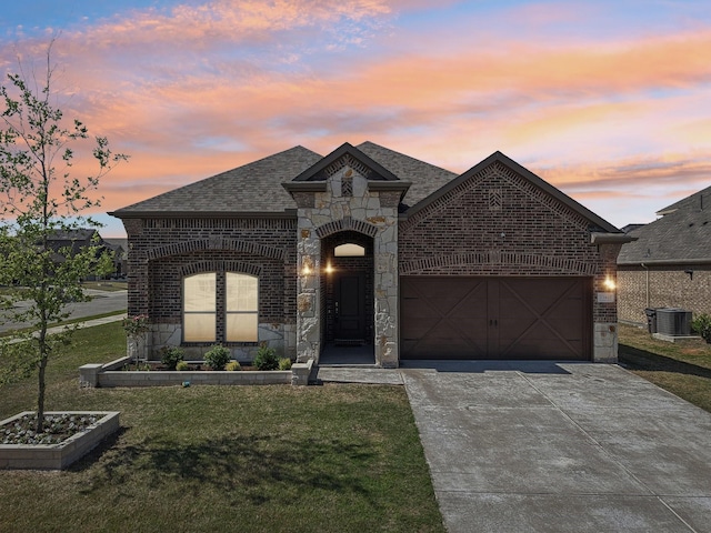 13412 Cortes De Pallas Dr, Little Elm, TX 75068 - french country home with brick siding, stone siding, an attached garage, a front lawn, and driveway